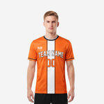 Custom soccer tops in orange and white with black trim, front view showing team name and number print on men's short sleeve jersey