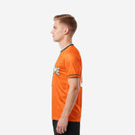 Custom soccer tops orange and white side view right showing vertical white center panel and full-dye sublimation print coverage