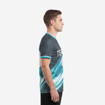 Custom soccer tops teal charcoal left side view showing diagonal gradient wave and sleeve cuff trim