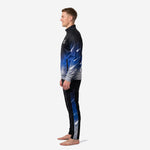 Dye sublimated soccer tracksuit in black and Royal Blue galaxy design, alternate side profile showing ribbed cuffs and tapered pant leg on men's model