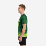 Custom soccer training jersey in Forest Green with Lime Green pine tree hem silhouette, right side view on male model