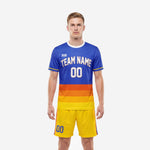 Custom soccer uniform kits in Royal Blue and Yellow with gradient orange banding, front view on male model