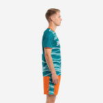 Custom soccer uniform kits teal and orange wave design, left side view showing sleeve cuff trim and shorts panel