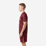 Mens custom soccer uniform maroon and gold right side view displaying dot-burst sublimated texture across jersey body