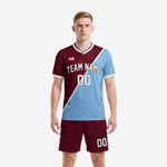 Custom soccer uniform men in maroon and powder blue diagonal colorblock jersey and matching maroon shorts, front view