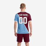 Custom soccer uniform maroon jersey close detail showing powder blue diagonal panel and white team name print