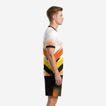 Left side view of custom soccer uniforms for teams package showing orange and yellow diagonal brush strokes and halftone dot pattern on white jersey and black shorts
