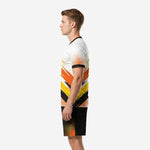 Right side view of men's custom soccer uniform kit in white, orange, and black showing full-dye sublimated brush-stroke design and matching shorts hem print