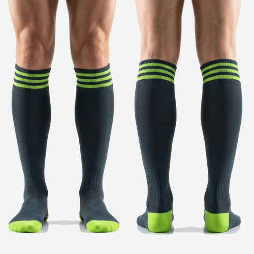 Full length view of custom black and green soccer socks over the calf fit worn by adult male player
