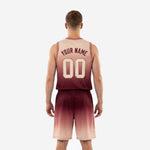 Right side view of custom sublimated basketball uniforms in maroon and blush showing full gradient fade on jersey and shorts