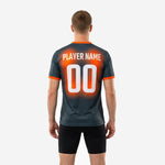 Detail view of full-dye sublimation print on graphite and orange custom mens soccer training top