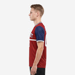 Custom sublimated red and navy soccer jersey in athletic cut showing full-dye print on 100 percent polyester performance fabric