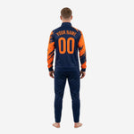 Close detail of custom soccer training tracksuit jacket collar, full-zip, and orange splash sublimation print on navy blue polyester