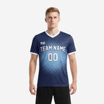 Custom sublimation soccer jersey design in Navy Blue and Sky Blue dot-burst gradient, front view on adult male model showing team name and number print