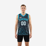 Custom teal basketball jerseys front and back showing full charcoal geometric cracked-stone pattern with teal V-neck binding and arced team name across the chest
