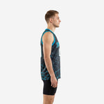 Front view of custom teal basketball jerseys with charcoal base geometric print and teal armhole binding on adult male model