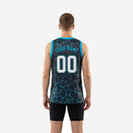 Opposite side view of custom teal basketball jerseys displaying the charcoal and teal cracked-stone sublimated print on adult male model