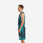 Side view of custom teal basketball uniforms showing teal armhole binding, chevron panel, and matching shorts with angular side detail