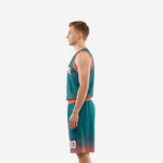 Side view of teal and coral custom basketball uniform showing coral armhole binding on jersey and halftone shorts hem detail