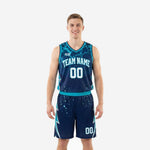 Custom teal basketball uniforms in navy and teal showing front and back of the full jersey and shorts set with lightning-bolt side panels and white team name