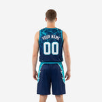 Opposite side view of the navy and teal custom basketball uniform set highlighting the continuous bolt graphic on the jersey side panel and shorts outer leg