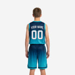 Opposite side view of custom teal youth basketball uniform showing athletic cut, drawcord waistband, and full-gradient shorts with side split detail