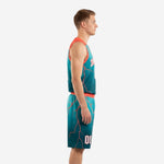 Side view of custom teal basketball uniform set showing coral-red lightning pattern across jersey and shorts leg panel