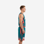 Custom teal basketball uniforms side view showing coral lightning bolt panel on jersey and matching shorts with hexagonal dot hem fade