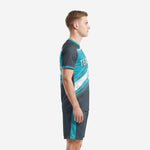 Custom teal soccer uniform set left side view showing teal side stripe on charcoal shorts and sublimated jersey