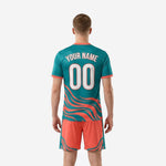 Close detail of teal soccer jersey wave print with full-dye sublimation and coral contrast sleeve trim