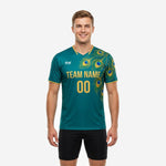 Custom teal and gold green soccer training jersey front view showing peacock feather graphic and team name print on male model