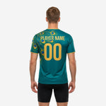 Close-up of peacock feather sublimation graphic on teal green soccer training jersey with iridescent blue and gold detail