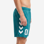 Custom green soccer shorts showing white chevron side panel graphic on left leg, side view on adult male model