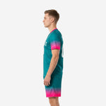 Custom teal soccer uniform right side view displaying full hot pink gradient fade from sleeve cuff to shorts hem