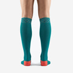 Turquoise soccer socks with geometric cross-stitch cuff detail in coral, custom made to order for club and team squads