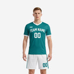 Custom teal men soccer outfit with white side panels and matching shorts, front view