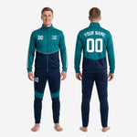 Custom teal and navy soccer tracksuit full two-piece set showing jacket and tapered pants together on adult male model