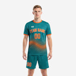 Custom teal soccer uniforms with orange dot-burst sublimation print, front view of 2-piece jersey and shorts set