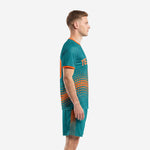 Custom teal and orange soccer uniform left side view showing dot-burst pattern across jersey and shorts panels