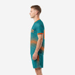 Custom teal soccer uniforms right side view with orange contrast cuff trim and sublimated shorts side panel