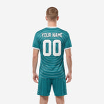 Teal soccer uniform jersey detail view of full-dye sublimation concentric white arc pattern with team name and number placement