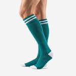 Custom teal soccer socks angled view showing double white stripe cuff band and clean teal calf panel