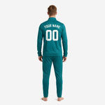 Custom teal soccer tracksuit back view showing white player name arc and large back number on full-zip jacket with matching tapered pants