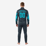 Custom teal soccer tracksuit splash print detail on charcoal fabric showing edge-to-edge sublimation print coverage
