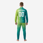 Teal soccer tracksuit gradient detail showing full-dye sublimation color fade from deep teal to bright lime green across jacket panels