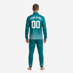 Teal soccer tracksuit jacket detail showing stand collar, full-zip closure, and white three-line sleeve stripe on 100 percent polyester fabric