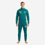 Custom teal soccer tracksuit with neon yellow digital camo side panels, full-zip jacket and tapered pants, front view