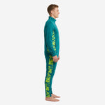 Teal soccer tracksuit left side view showing neon yellow digital camo panel running from armhole to ankle