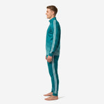 Custom teal soccer tracksuit side profile displaying full-dye sublimation wave graphic fading from hem to solid teal chest on stand-collar jacket