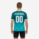 Teal soccer training jersey front detail showing deep teal gradient fading to aqua with white V-neck collar trim